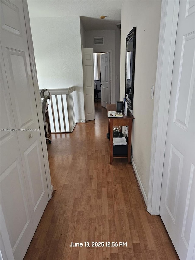 11401 NW 76th Ter, Doral, FL 33178 - corridor featuring wood finished floors and an upstairs landing