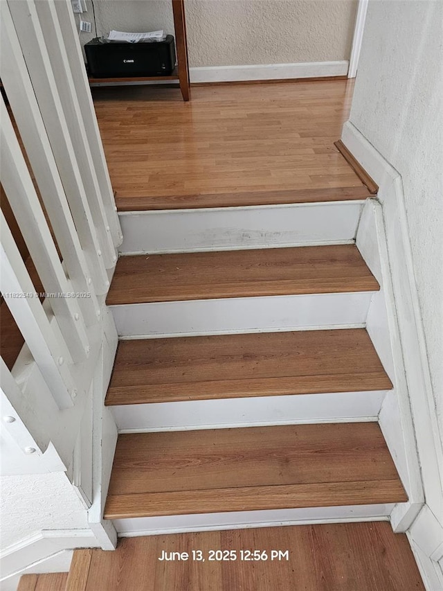 11401 NW 76th Ter, Doral, FL 33178 - stairs with a textured wall and wood finished floors