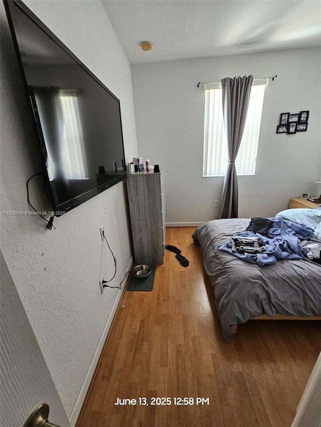 11401 NW 76th Ter, Doral, FL 33178 - bedroom featuring baseboards and light wood-style flooring