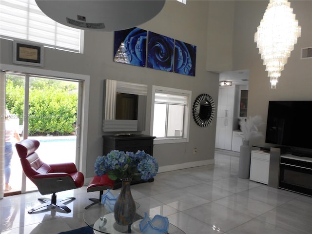12940 SW 142nd Ter, Miami, FL 33186 - living area featuring a high ceiling, healthy amount of natural light, and a chandelier