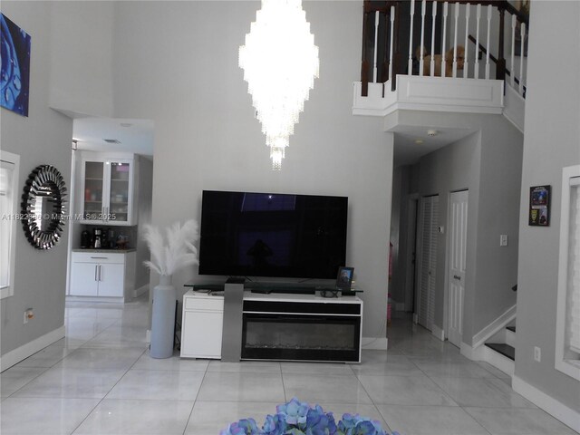 12940 SW 142nd Ter, Miami, FL 33186 - living room with a high ceiling, stairway, and a chandelier