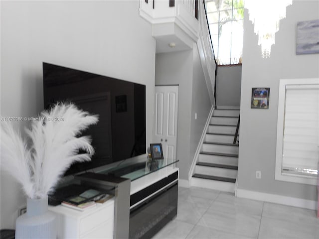 12940 SW 142nd Ter, Miami, FL 33186 - staircase with a chandelier, marble finish flooring, and a towering ceiling