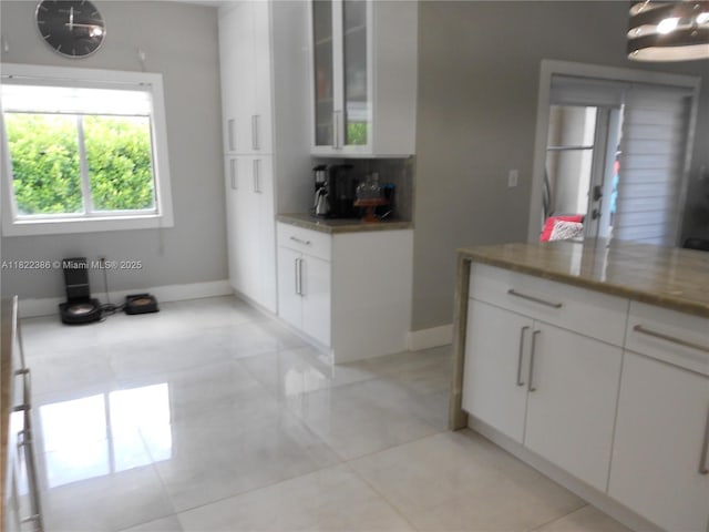 12940 SW 142nd Ter, Miami, FL 33186 - kitchen with white cabinets, glass insert cabinets, light tile patterned floors, and tasteful backsplash