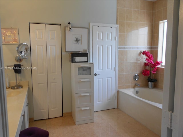 12940 SW 142nd Ter, Miami, FL 33186 - bathroom featuring tile patterned flooring, vanity, a bathtub, and a closet