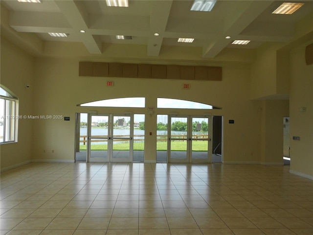 12940 SW 142nd Ter, Miami, FL 33186 - empty room with coffered ceiling, healthy amount of natural light, a towering ceiling, beam ceiling, and a water view