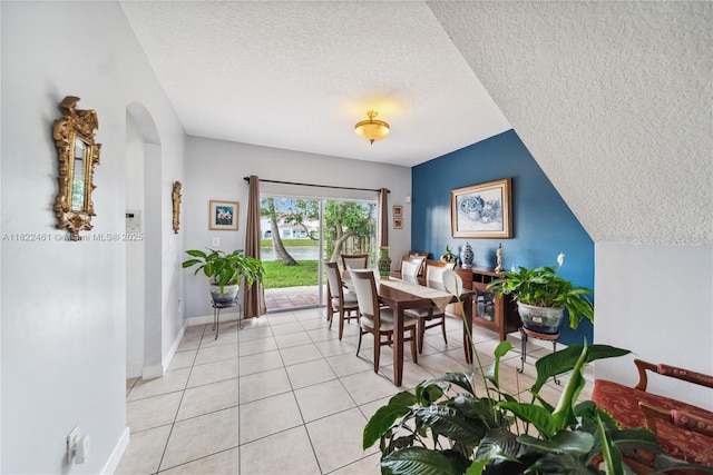 11018 NW 47th Ter, Doral, FL 33178 - dining room with a textured ceiling, arched walkways, and light tile patterned flooring