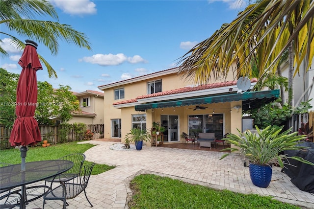 11018 NW 47th Ter, Doral, FL 33178 - back of house with stucco siding, a patio area, ceiling fan, outdoor dining space, and a tiled roof