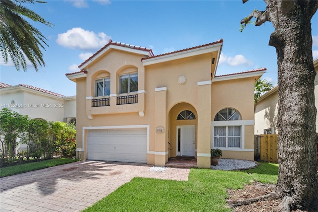 11018 NW 47th Ter, Doral, FL 33178 - mediterranean / spanish home featuring stucco siding, an attached garage, a tiled roof, and decorative driveway
