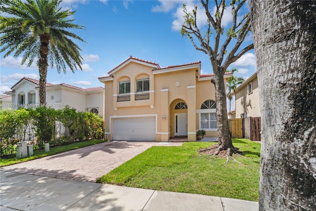 11018 NW 47th Ter, Doral, FL 33178 - mediterranean / spanish house featuring stucco siding, a tiled roof, decorative driveway, and a garage
