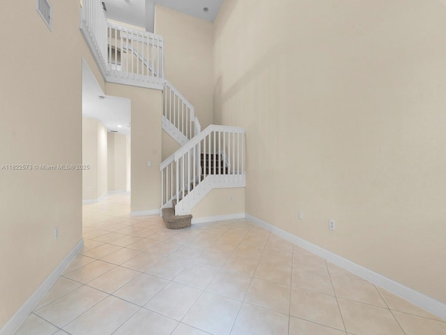 2590 SE 14th St, Homestead, FL 33035 - staircase with tile patterned floors and a towering ceiling