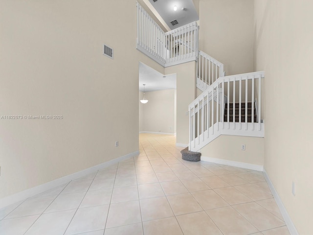 2590 SE 14th St, Homestead, FL 33035 - staircase featuring a towering ceiling and tile patterned flooring