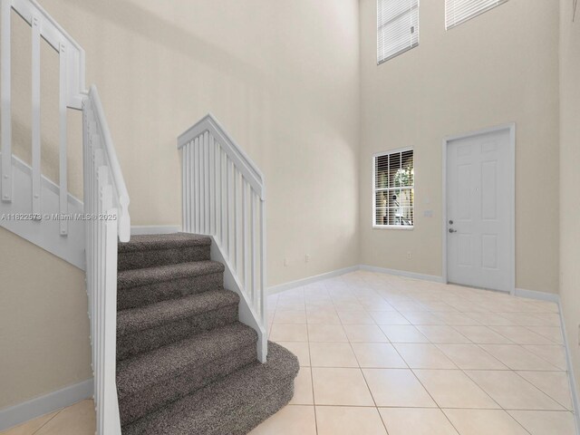 2590 SE 14th St, Homestead, FL 33035 - entrance foyer featuring a towering ceiling, stairs, and light tile patterned floors
