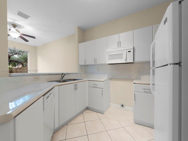 2590 SE 14th St, Homestead, FL 33035 - kitchen featuring white appliances, light countertops, a ceiling fan, and light tile patterned floors