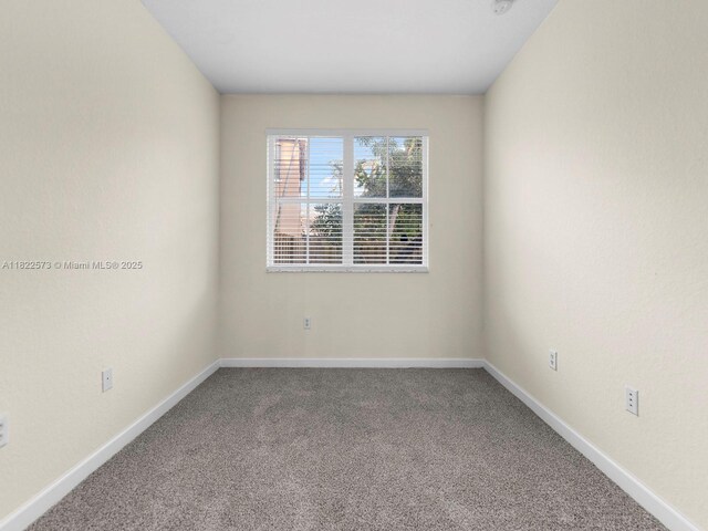 2590 SE 14th St, Homestead, FL 33035 - carpeted empty room with baseboards