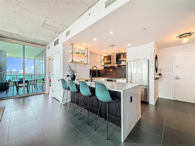 3301 NE 1st Ave Unit H1215, Miami, FL 33137 - kitchen with built in fridge, open shelves, backsplash, a breakfast bar, and light countertops