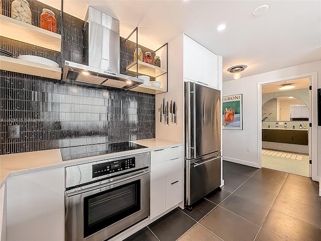 3301 NE 1st Ave Unit H1215, Miami, FL 33137 - kitchen featuring stainless steel appliances, open shelves, wall chimney range hood, dark tile patterned flooring, and backsplash