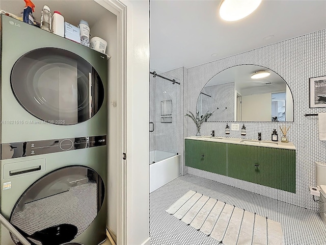 3301 NE 1st Ave Unit H1215, Miami, FL 33137 - full bathroom with stacked washer / dryer, combined bath / shower with glass door, vanity, and tile patterned flooring