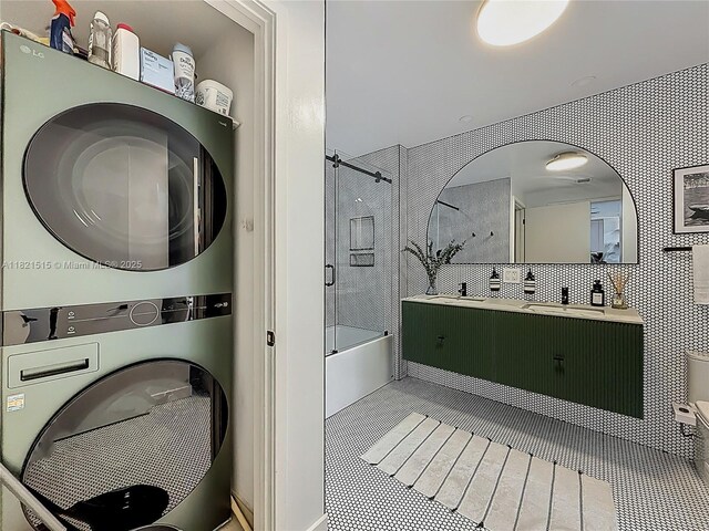 3301 NE 1st Ave Unit H1215, Miami, FL 33137 - bathroom featuring stacked washer / dryer, bathtub / shower combination, vanity, and tile patterned flooring