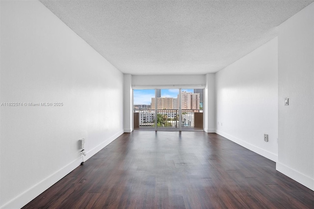 1965 S Ocean Dr Unit 6Q, Hallandale Beach, FL 33009 - empty room featuring a textured ceiling, dark wood-style flooring, and a view of city
