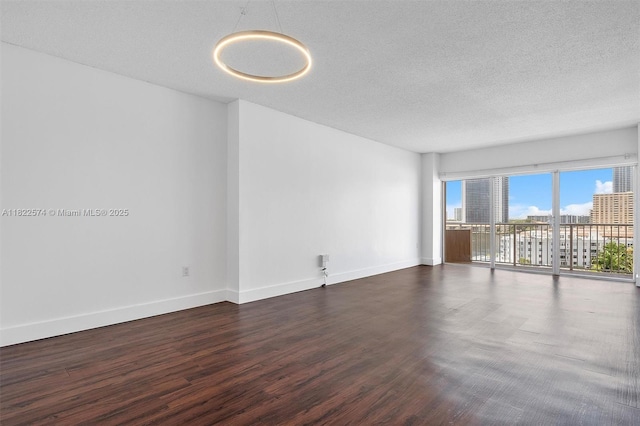 1965 S Ocean Dr Unit 6Q, Hallandale Beach, FL 33009 - empty room with dark wood-style flooring and a textured ceiling