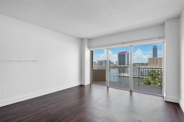 1965 S Ocean Dr Unit 6Q, Hallandale Beach, FL 33009 - empty room featuring wood finished floors, a textured ceiling, and a city view
