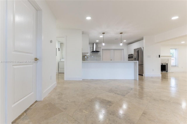 unfurnished living room with washer / dryer, recessed lighting, and a fireplace