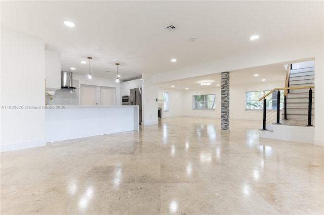 unfurnished living room featuring recessed lighting and stairs