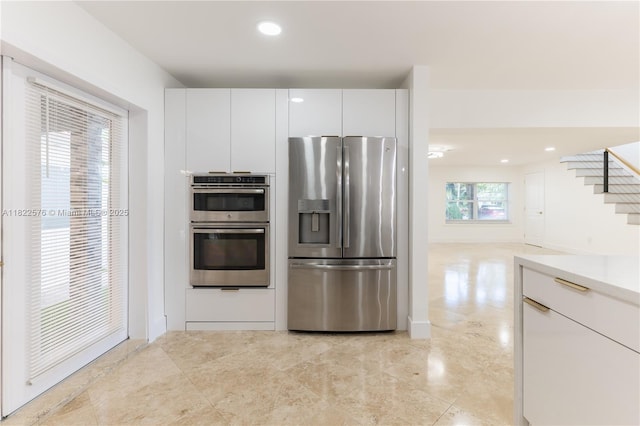 kitchen with appliances with stainless steel finishes, white cabinets, recessed lighting, light countertops, and modern cabinets