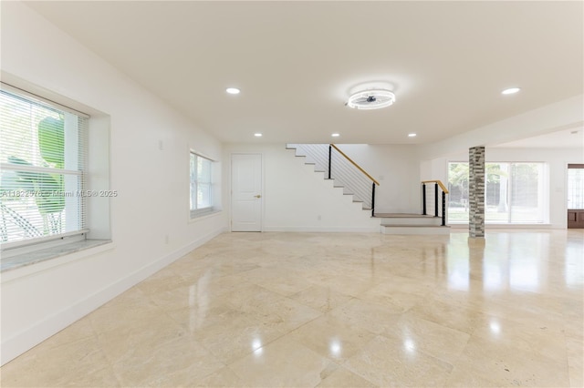 unfurnished living room with stairs and recessed lighting
