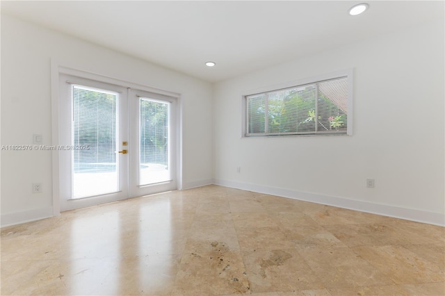unfurnished room featuring french doors and recessed lighting