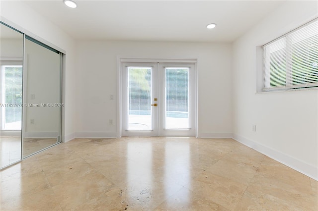 empty room featuring french doors and recessed lighting