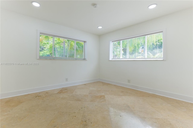 unfurnished room with recessed lighting and a smoke detector