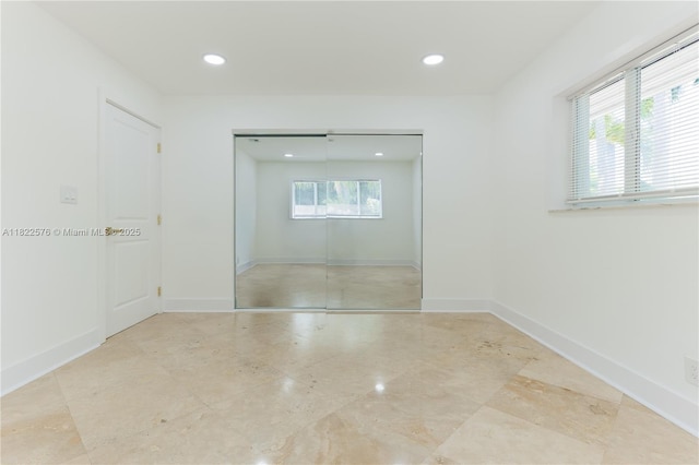 spare room featuring plenty of natural light and recessed lighting