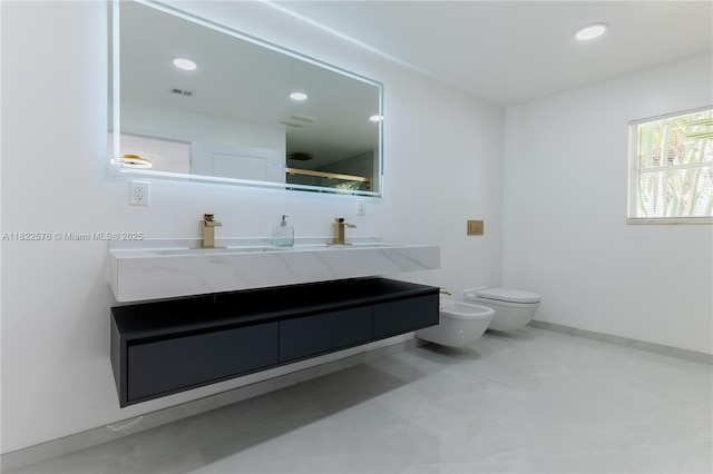 full bath featuring a bidet, double vanity, and recessed lighting