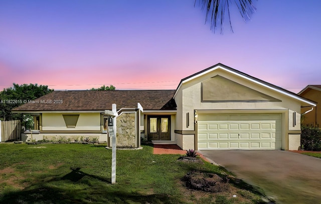 7220 NW 44th Ct, Lauderhill, FL 33319 - view of front of property featuring french doors, a garage, stucco siding, a yard, and concrete driveway