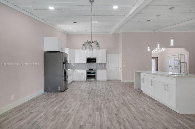 7220 NW 44th Ct, Lauderhill, FL 33319 - kitchen featuring stainless steel appliances, a chandelier, backsplash, white cabinetry, and light countertops