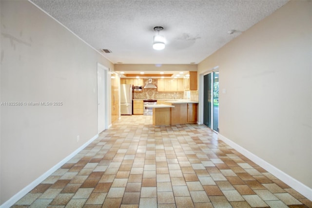 1531 SW 67th Ter, Plantation, FL 33317 - kitchen with freestanding refrigerator, extractor fan, light countertops, a textured ceiling, and tasteful backsplash