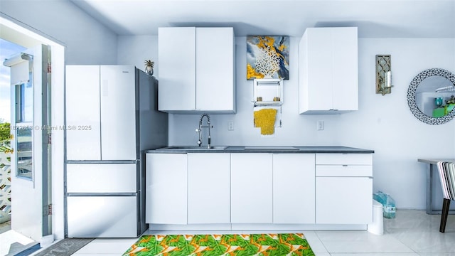 13105 Ixora Ct Unit 302, North Miami, FL 33181 - kitchen featuring freestanding refrigerator, white cabinets, modern cabinets, and dark countertops