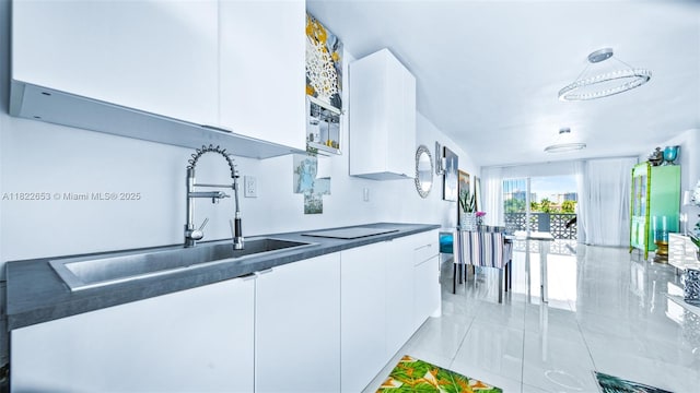 13105 Ixora Ct Unit 302, North Miami, FL 33181 - kitchen featuring dark countertops, white cabinets, modern cabinets, and light tile patterned flooring