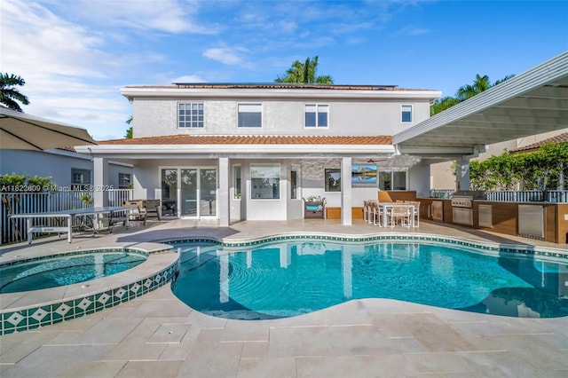 942 Lavender Cir, Weston, FL 33327 - view of pool with an outdoor kitchen, a patio area, a pool with connected hot tub, and a bar