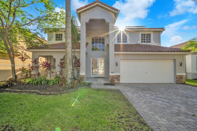 942 Lavender Cir, Weston, FL 33327 - mediterranean / spanish-style house with a tiled roof, stucco siding, decorative driveway, and stone siding