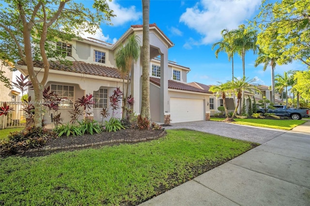 942 Lavender Cir, Weston, FL 33327 - mediterranean / spanish-style house featuring stucco siding, a tile roof, a front yard, and decorative driveway