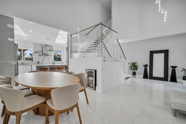 942 Lavender Cir, Weston, FL 33327 - dining room featuring stairs, wine cooler, a towering ceiling, and recessed lighting