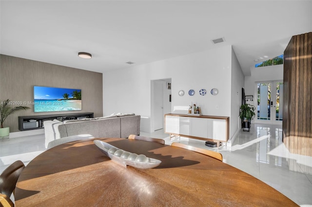 942 Lavender Cir, Weston, FL 33327 - dining room with an accent wall, tile patterned floors, french doors, lofted ceiling, and wallpapered walls