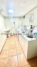 17570 Atlantic Blvd Unit 119, Sunny Isles Beach, FL 33160 - kitchen with tile patterned floors and light countertops