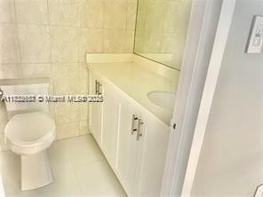 17570 Atlantic Blvd Unit 119, Sunny Isles Beach, FL 33160 - bathroom featuring vanity, tile walls, and tile patterned floors