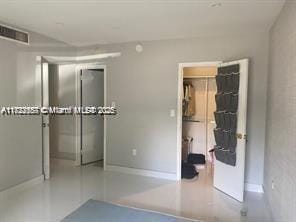 17570 Atlantic Blvd Unit 119, Sunny Isles Beach, FL 33160 - unfurnished bedroom with a walk in closet and a closet
