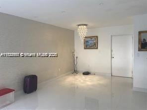 17570 Atlantic Blvd Unit 119, Sunny Isles Beach, FL 33160 - unfurnished room featuring a chandelier and baseboards