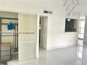 17570 Atlantic Blvd Unit 119, Sunny Isles Beach, FL 33160 - unfurnished room with a chandelier and baseboards