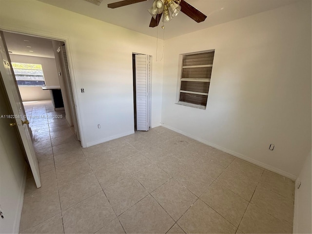 9801 SW 56th St, Miami, FL 33165 - spare room with light tile patterned floors, ceiling fan, and built in shelves